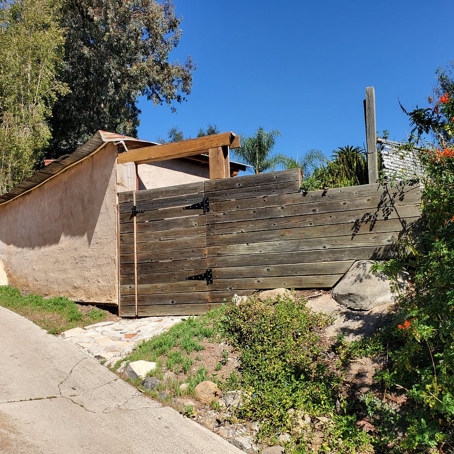 Gate to fenced yard patio and 2 entry doors of Suite
