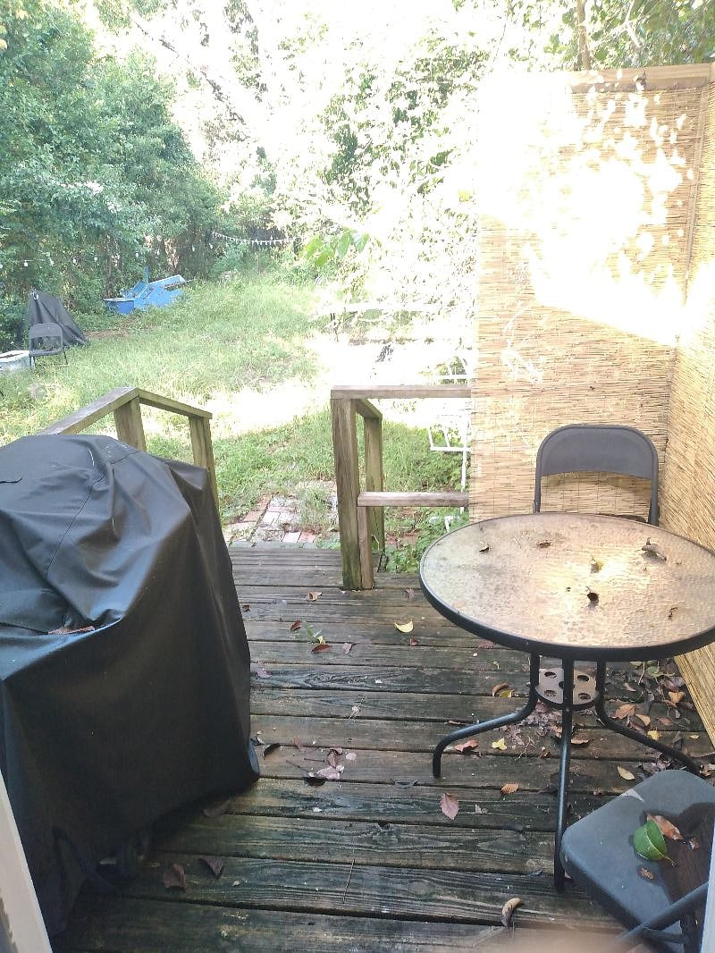 Backyard deck, access from bathroom. Grill, table, outdoor shower, yard.