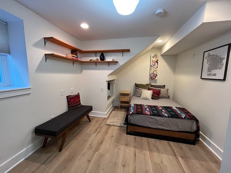 Bedroom with large shaded window.