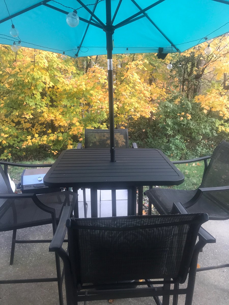 Cozy back porch area with a table and chairs. 