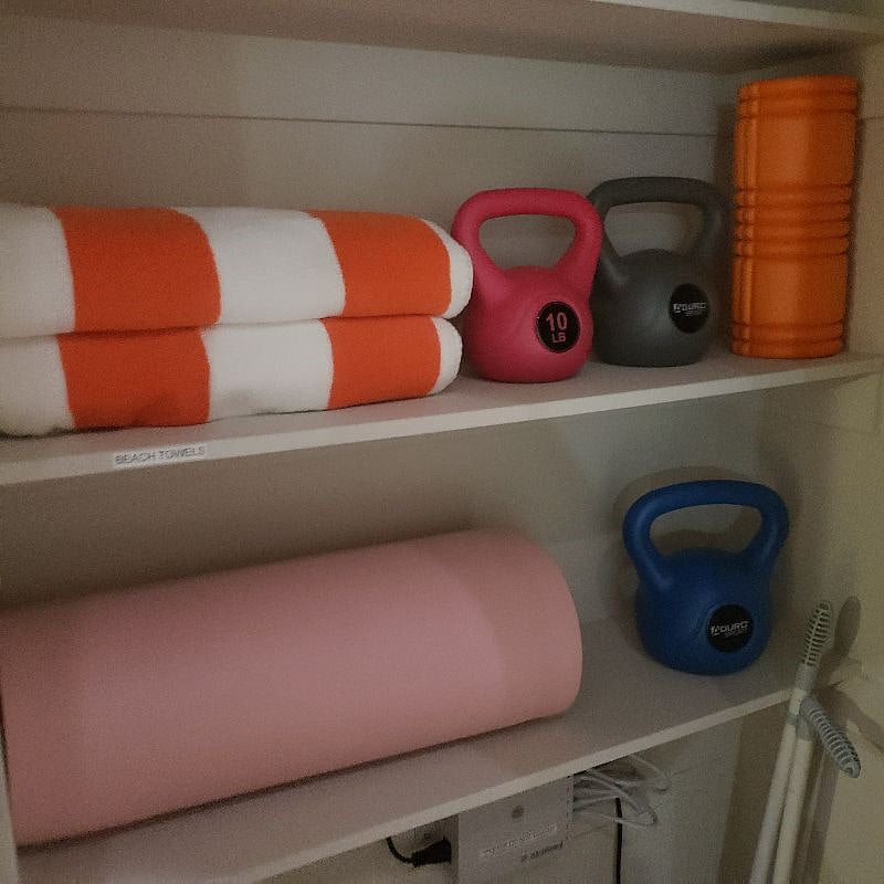 Beach towels, yoga mat, kettlebells and roller.