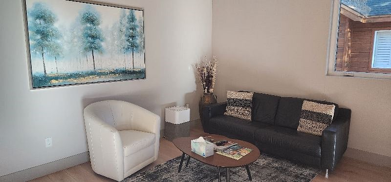 Upscale living area with Natuzzi leather seating.