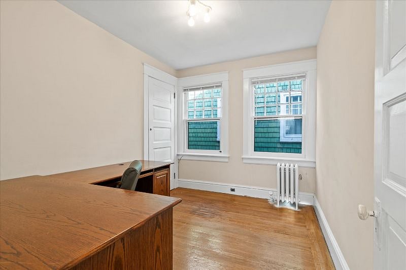 Bedroom #2 with large desk and chair. Closet extends deeply and provides extra storage space.