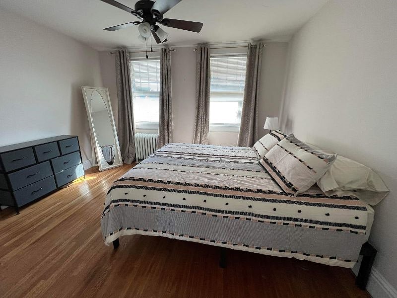 Bedroom #1 with bedding and dresser.
