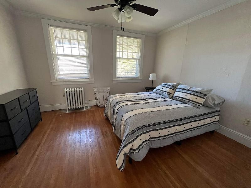Bedroom #3 with bedding and dresser.