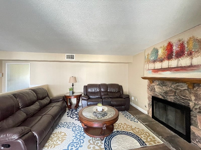 Back sitting room with direct sight lines to dining and kitchen area