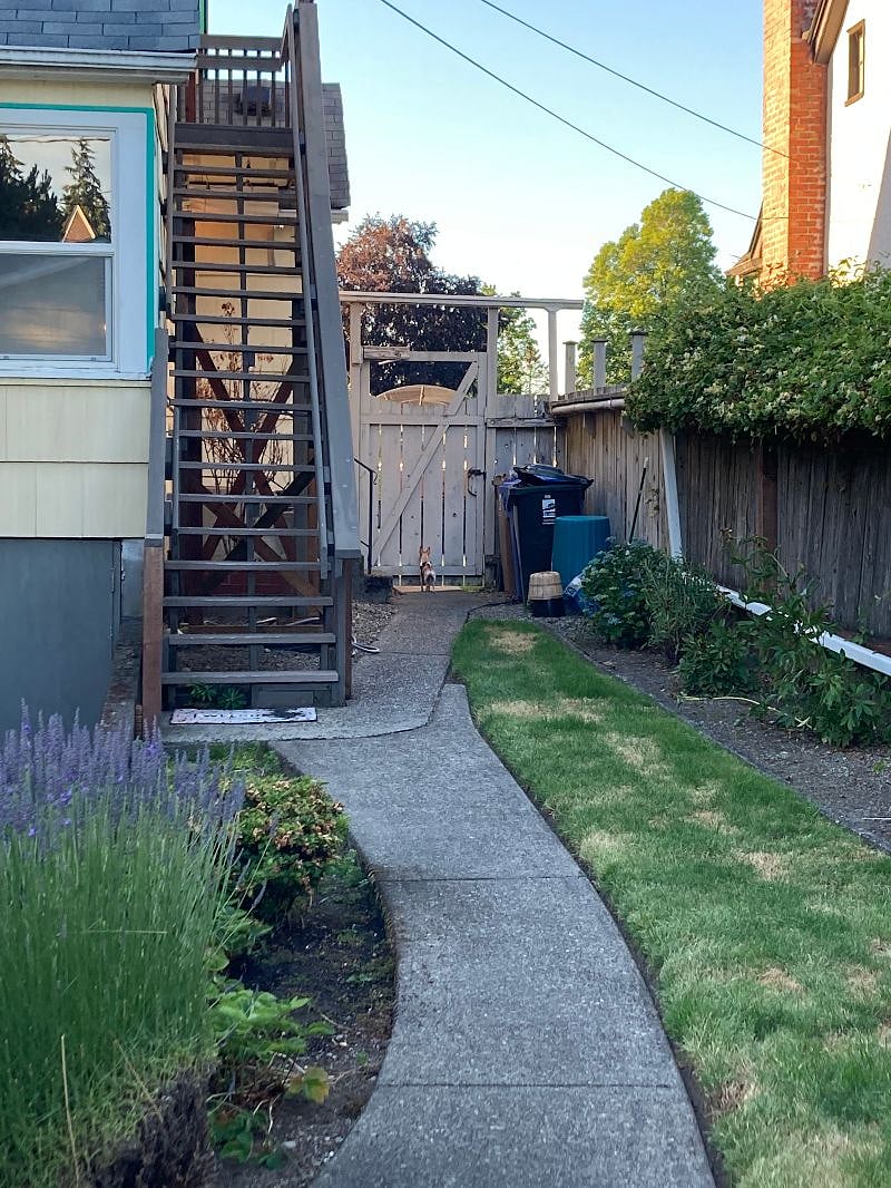 exterior staircase to private entrance with full fenced yard with security lights for safety 