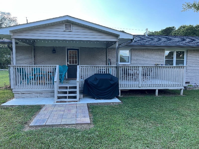 10x24ft Back Deck partially covered. 6 Adirondack chairs, Wrought-ironed table w/4 chairs, Char-Broil Grill w/2 propane tanks.