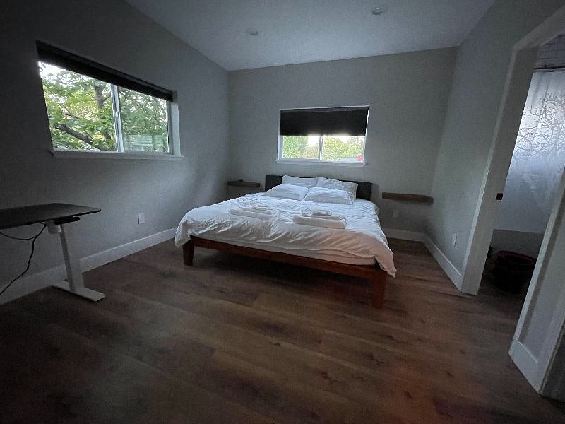 Bedroom 1 with shades open showing natural lighting.