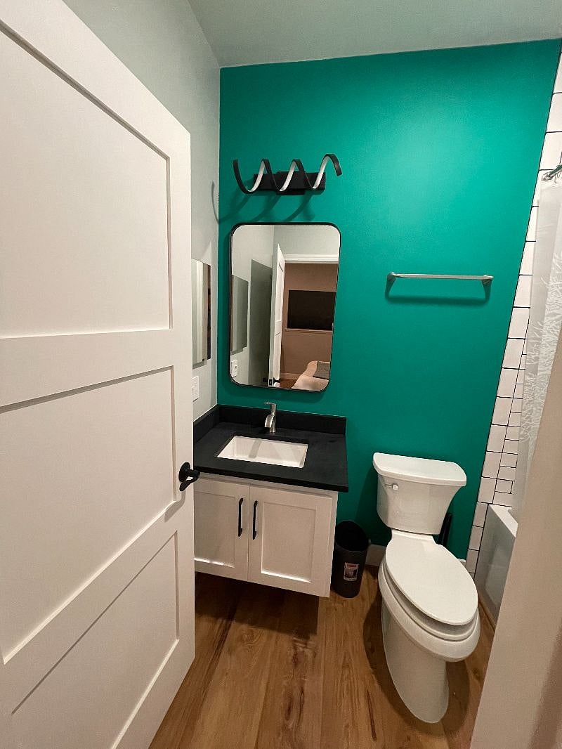 Bathroom 2 with aqua green accent wall. Enjoy the floating vanity, comfort height toilet, and added storage inside in-wall medicine cabinet that are in each bathroom as well.