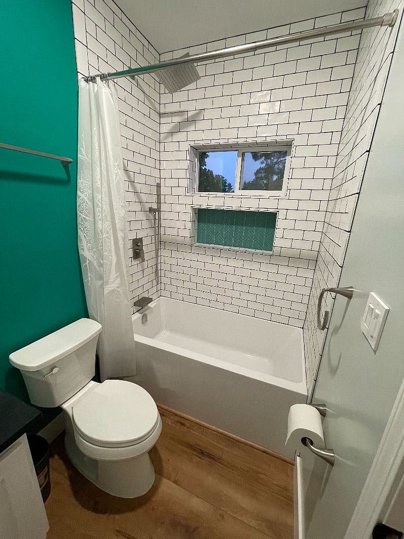 Bathroom 2 view of the shower with oversized ledge for all your shower product storage needs.