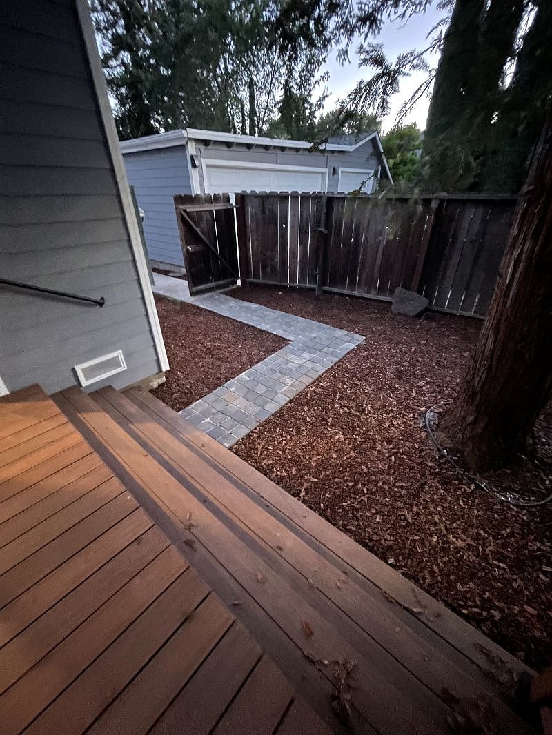 Walkway leading from driveway gate entrance to deck.