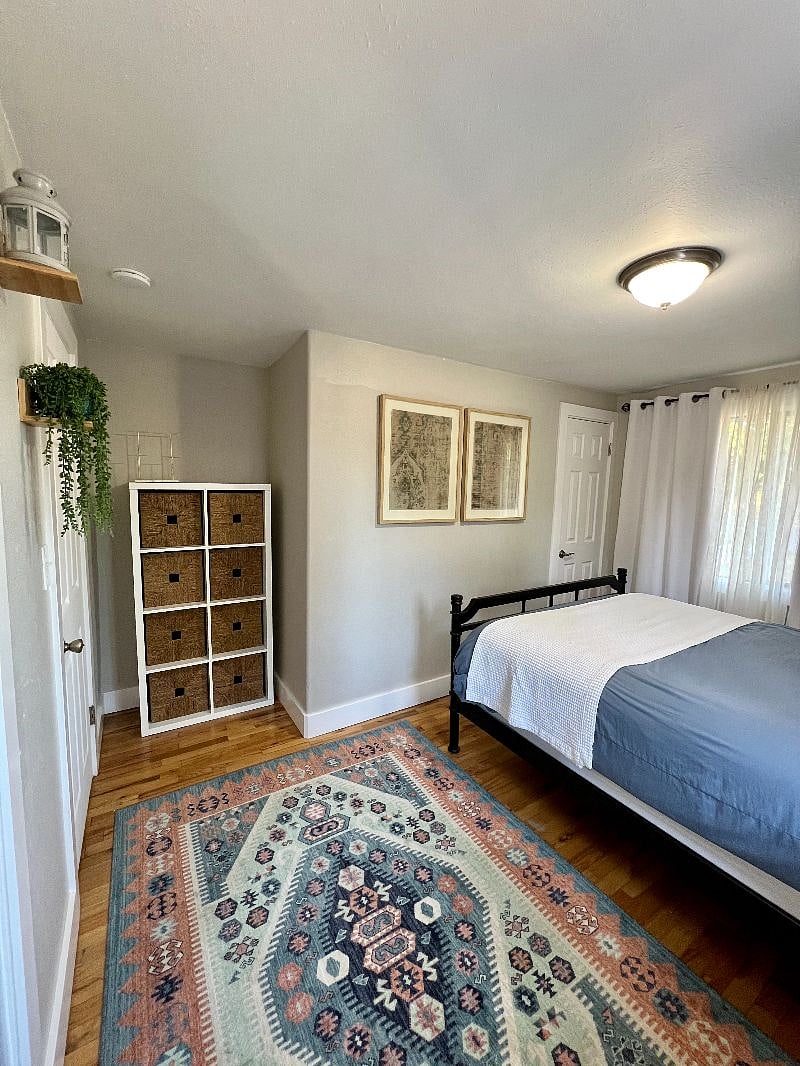 Primary bedroom with a dresser and dual closets 