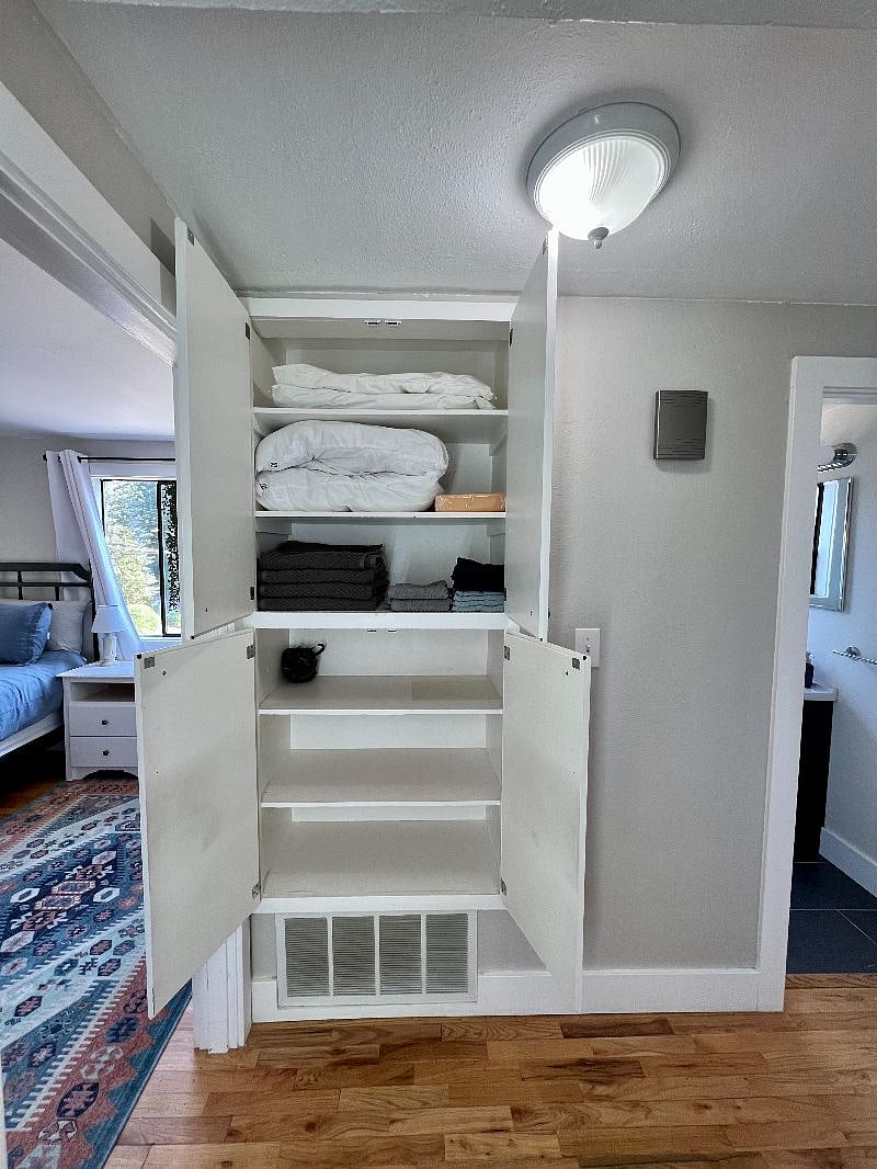 Hallway closet with towels, extra linen, and pillows