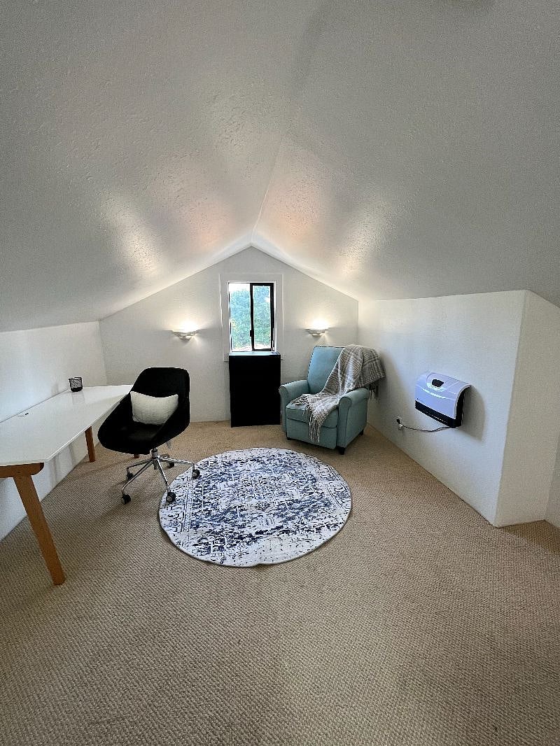 Massive loft space with desk and cozy reading nook. The other side of this space is perfect for storage
