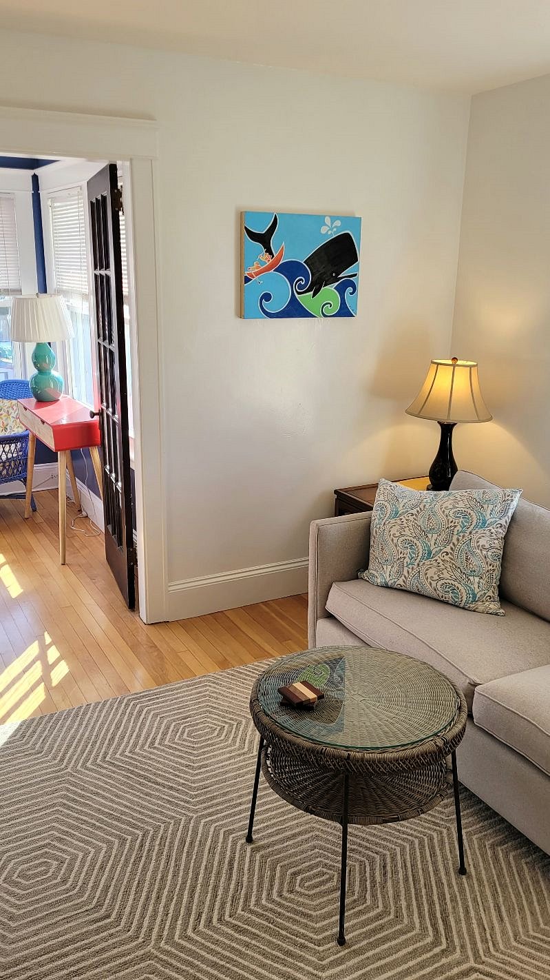 Looking from the living room to the sun room with an original painting by Marie Ahearn.