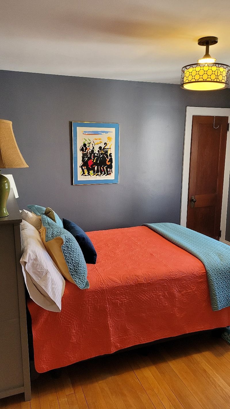 Main bedroom with queen bed and small closet.