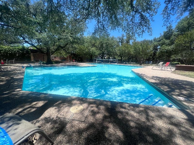 The neighborhood pool is about a 3 to 5 minute walk down the street. It features charcoal grills, covered picnic tables, and ample shade from mature live oaks. 