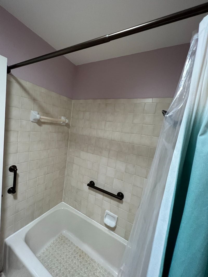 Grab bars and new travertine floor tile installed in 2019 