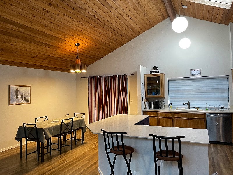 View of the kitchen area and dining area. Note the privacy blinds that are closed in this photo but of course can be opened to let in more light.