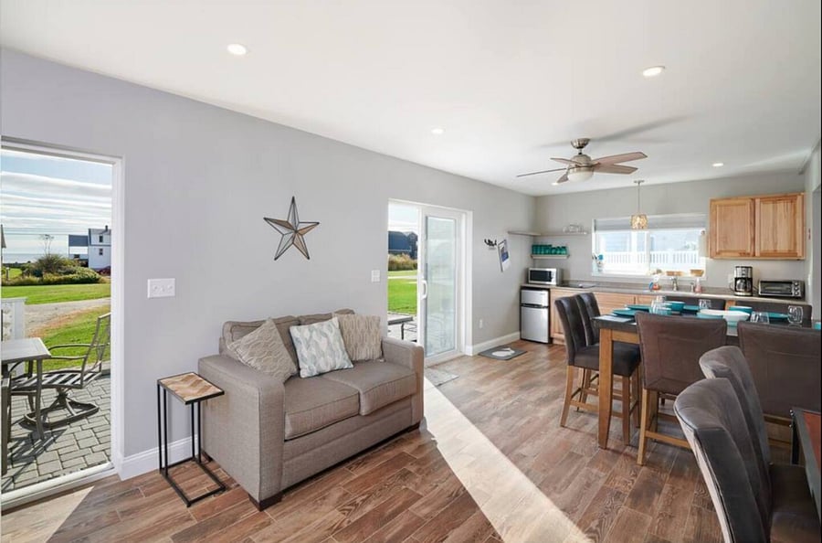 Main level unit kitchen and living room, with access to outdoor covered patio. 