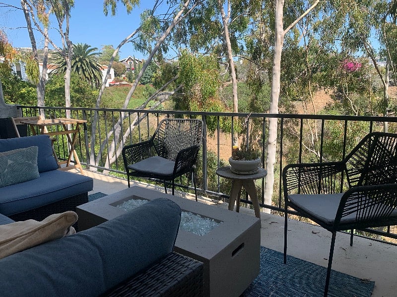Main deck with sectional seating, fire pit and hammock chair