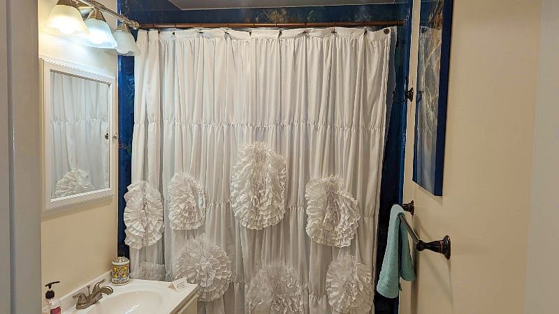 The bathroom has a shower and a tub.