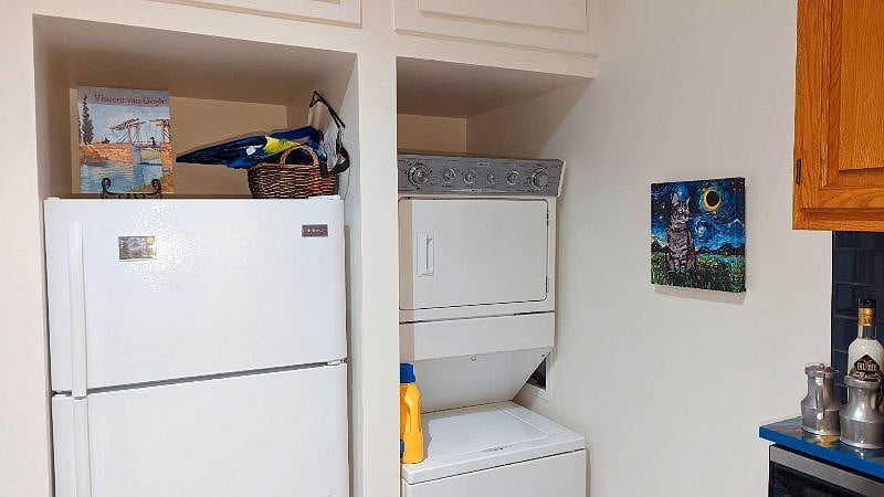 A washer and dryer is provided in unit, right next to the refrigerator.