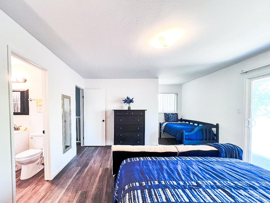 Sliding glass door to balcony is on the right. Bedroom door and the full bathroom is on the left.