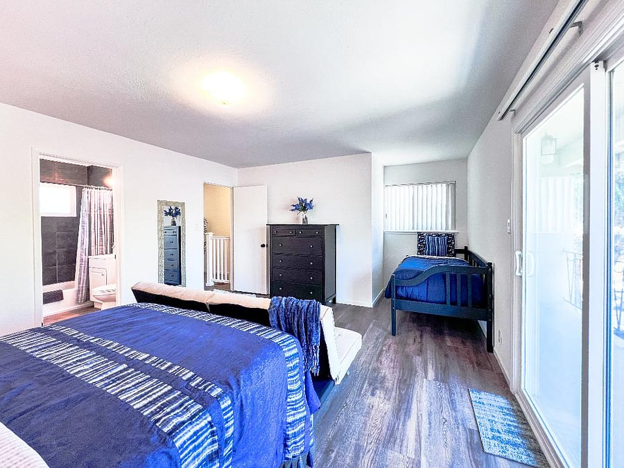 Sliding glass door to balcony is on the right. Bedroom door and the full bathroom is on the left.