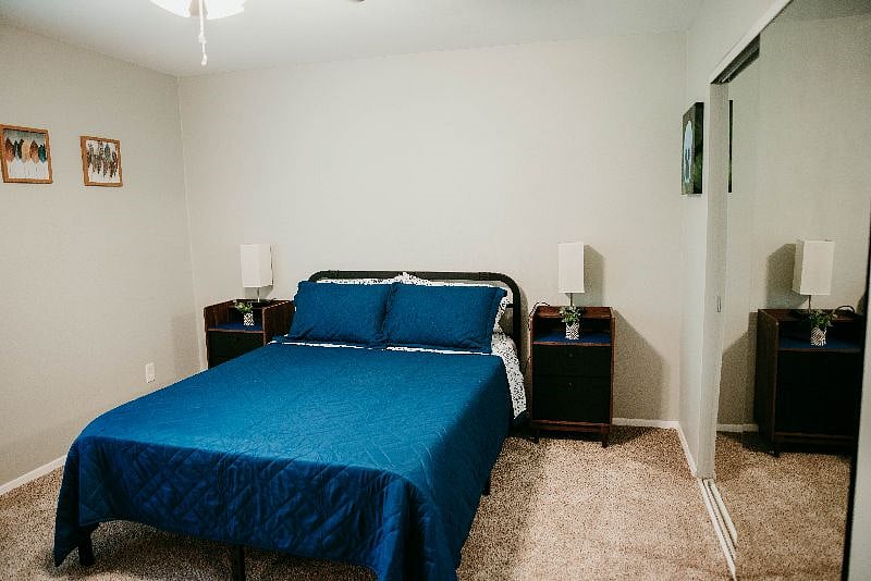 Master bedroom with attached full bathroom. Lamps have options for AC plug-in and a USB port.