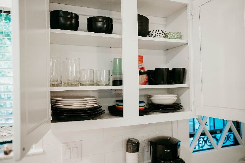 Cabinet has both stoneware and plasticware and children's plate/bowls as well as coffee, creamer and sugar for your morning cup of joe!