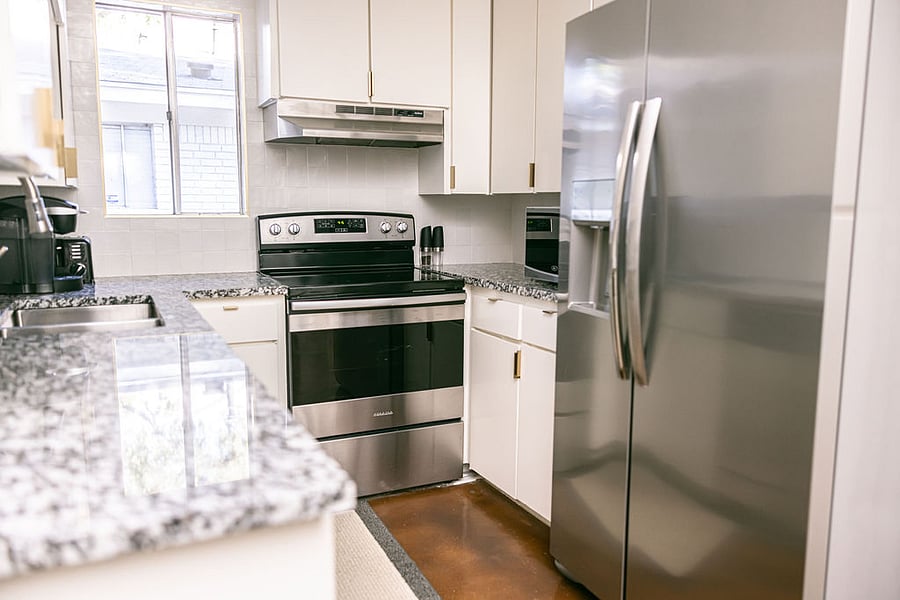 Fully equipped, updated, and stocked kitchen with stainless / black appliances. New Kitchenaide refrigerator..