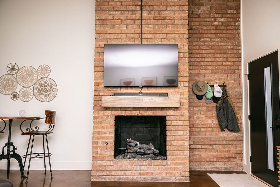 Living area: Fireplace, 55 Smart Samsung TV, Sony soundbar with wireless subwoofer (not shown).