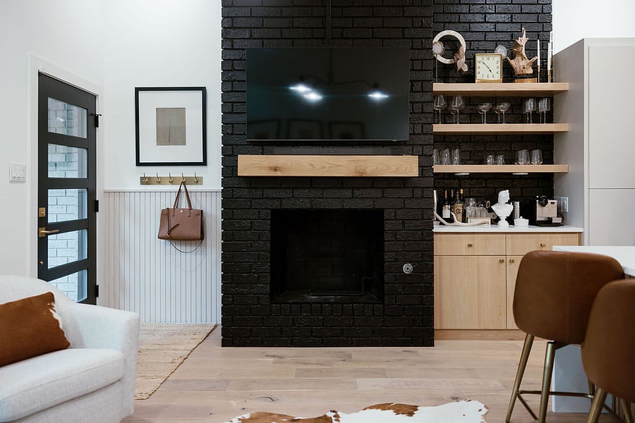 Ventless gas-log fireplace with Samsung 55 SMART TV mounted above. Fireplace capable of heating entire townhome!