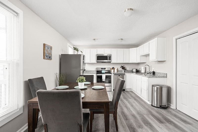 A chic dining space adorned with an elegant table, ideal for communal meals and gatherings.
