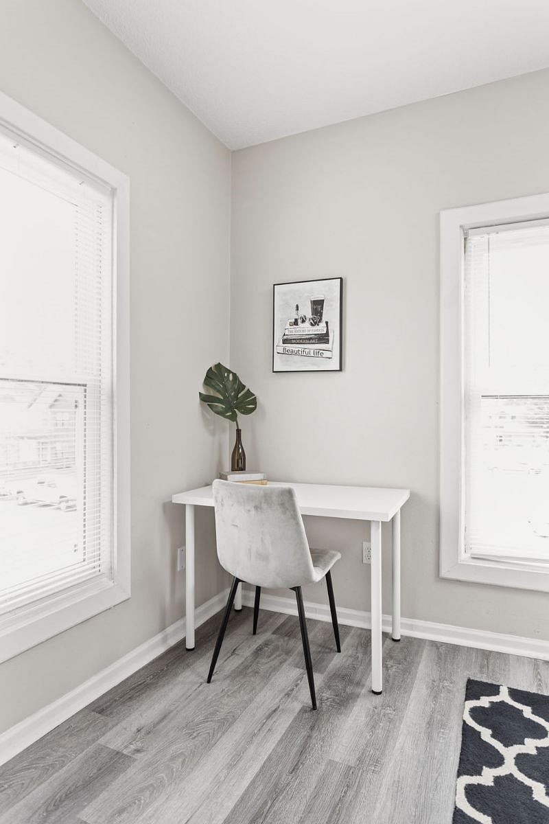 A workspace positioned near the windows to provide a well-lit setting for productivity.