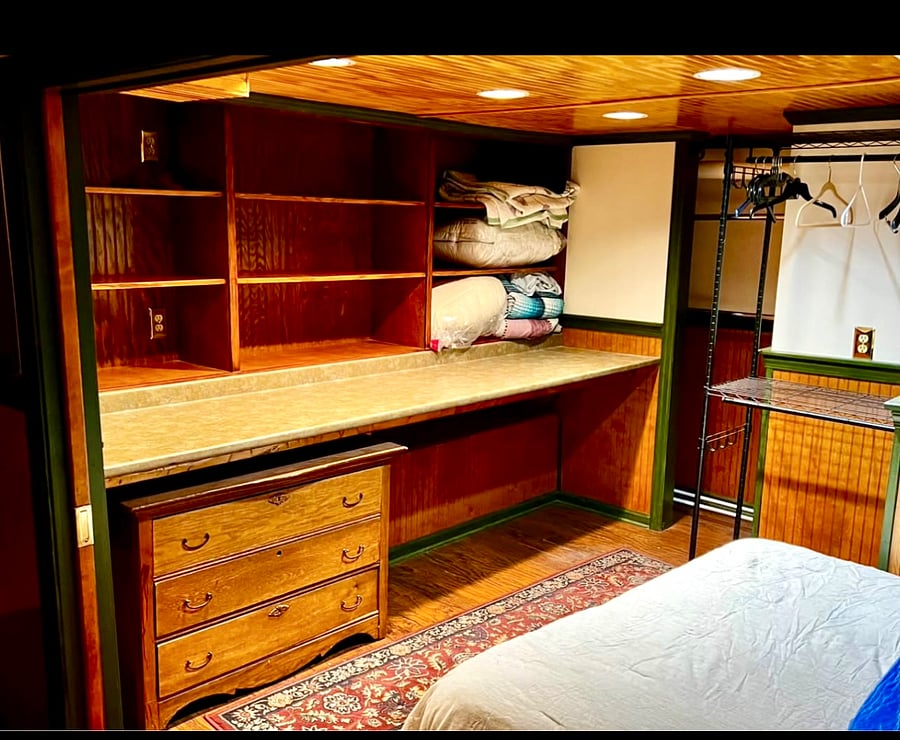 Dresser, shelving and closet in bedroom