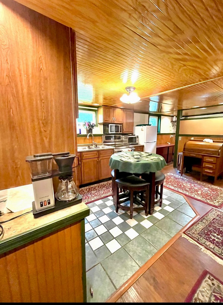 Kitchen includes fridge, toaster oven, microwave, disposal, bar/drink fridge, wine rack, all kitchen needs - utensils, pots, pans, dishes, cups, glasses, table with stools