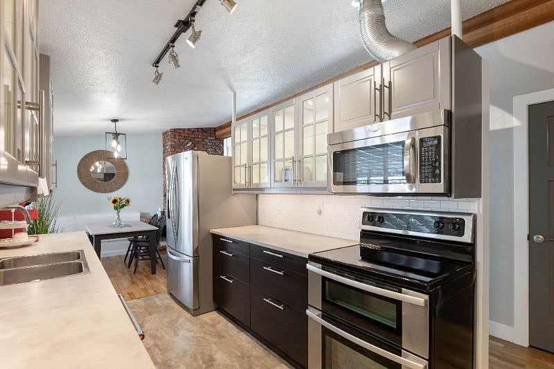 Kitchen includes many small appliances, air fyer, blender, hand mixer etc.