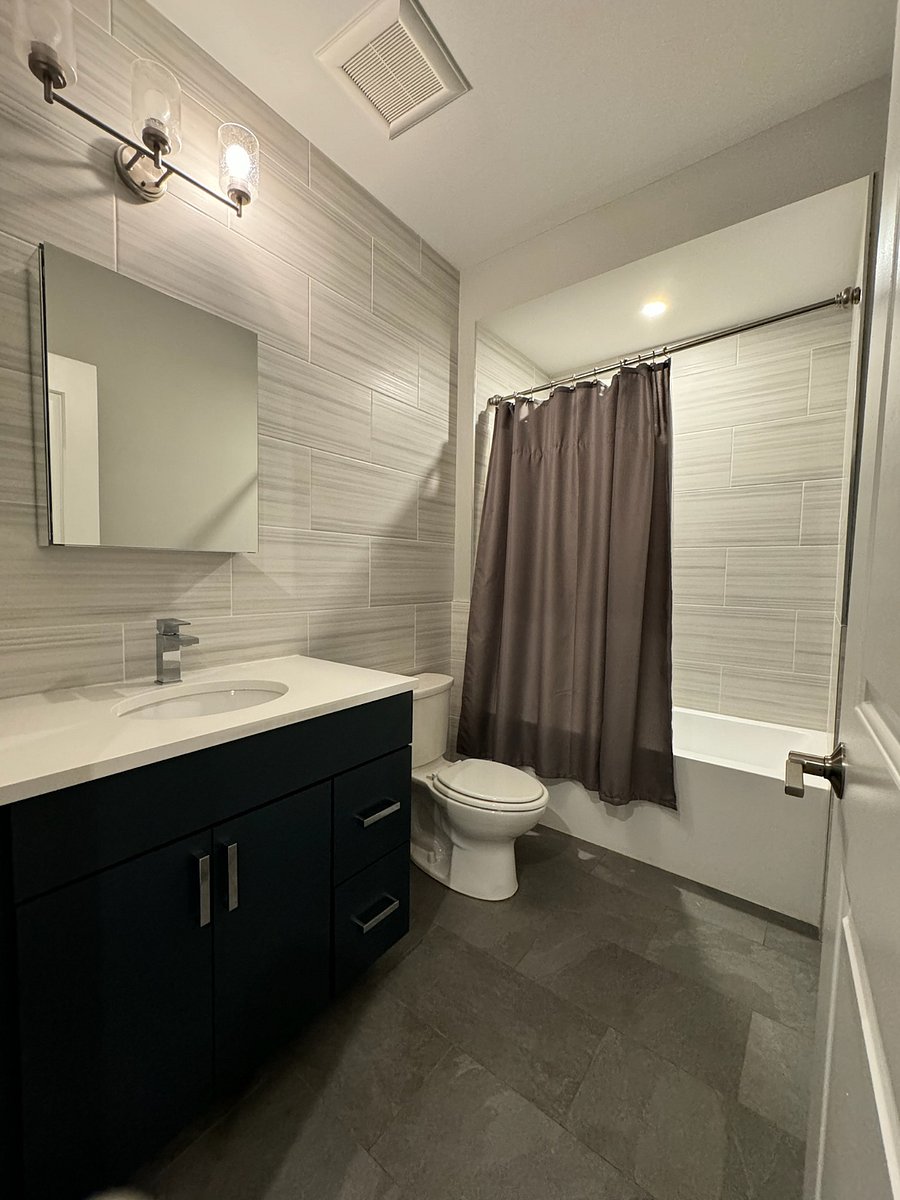 Bathroom located outside of room. same level