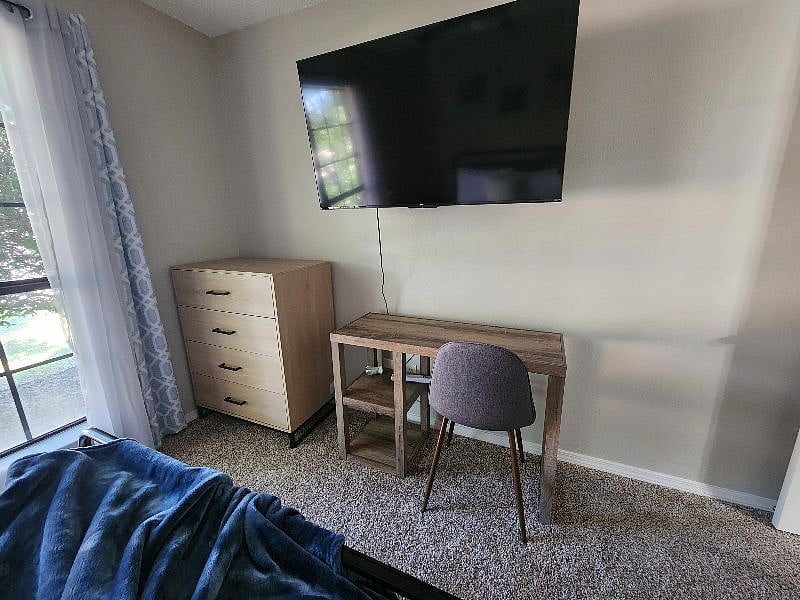 Guest Bedroom with desk and TV