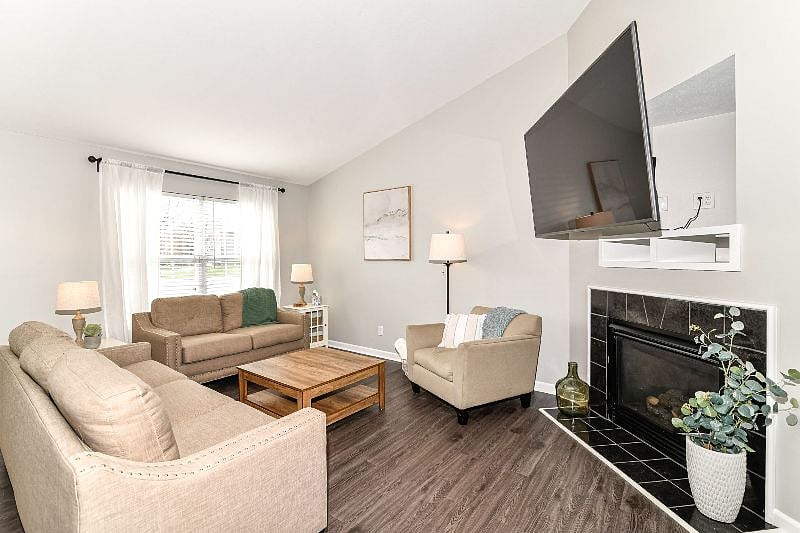 Living room with gas fireplace and large smart TV