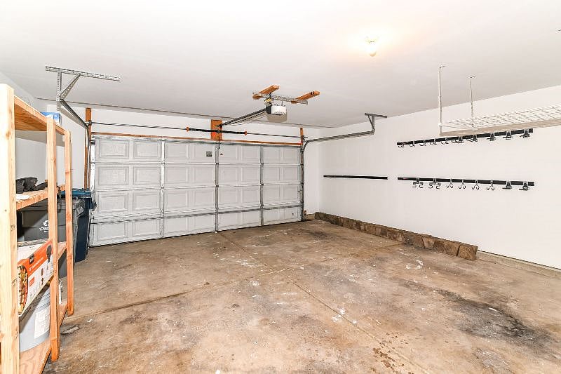 2 Car Garage with shelving and hooks for storage.
