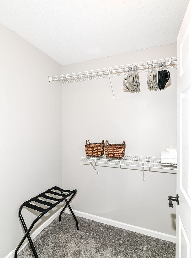 Large closet spaces with hangers and storage options (this is the master closet).