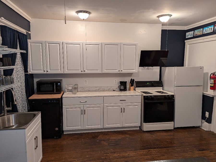 Full kitchen with dishwasher and gas range