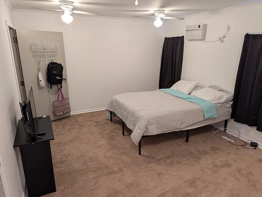 Bedroom with black-out curtains and shades