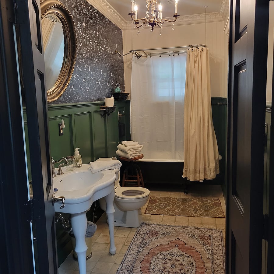 Bathroom includes a clawfoot tub and shower, and a laundry room off of  the bathroom.