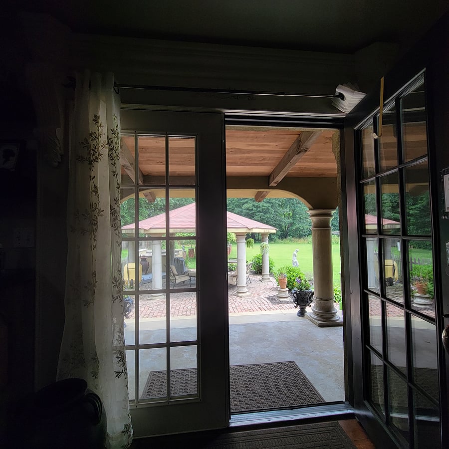 View of the back porch looking out into the gazebo and grapevine.