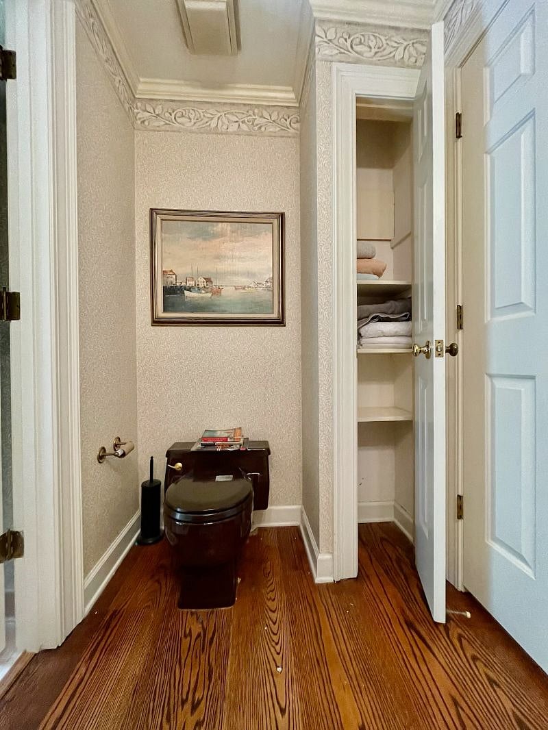bathroom toilet and closet; door on left is to shower room